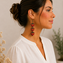 Cargar imagen en el visor de la galería, Model wearing Autumn Ember hand-painted wooden earrings at a realistic scale.