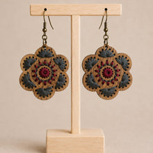 Load image into Gallery viewer, Crimson Roots embroidered wooden earrings displayed front-facing on a light wood stand.