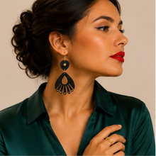 Load image into Gallery viewer, Model wearing Ebony Moon wooden earrings with an emerald satin blouse and red lipstick, showing the earrings at realistic scale.