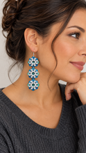 Load image into Gallery viewer, Model wearing Frozen Sky lightweight layered snowflake wooden earrings with silver-tone hooks