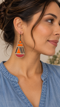 Load image into Gallery viewer, Model wearing a geometric teardrop wooden earring with a soft denim-blue top, showing the 3-inch statement earring at a natural scale.