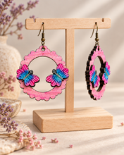 Load image into Gallery viewer, Mariposa Serena wooden earrings shown at an angle to highlight the raised hand-painted butterfly pieces