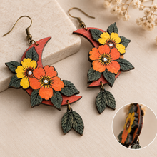 Load image into Gallery viewer, Moon Flower wooden earrings shown at an angle highlighting layered flowers, engraved leaves, and hand-painted texture