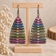Load image into Gallery viewer, Pearlescent Rainbow hand-painted multicolor wooden earrings on a light wood stand
