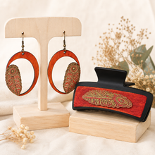 Load image into Gallery viewer, Tribal Feather large hair clip and matching lightweight wooden earrings displayed together on a light wood stand and plinth.