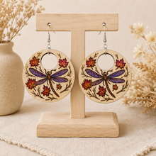 Load image into Gallery viewer, Autumn Wings hand-painted wooden earrings displayed front-facing on a light wood stand.

