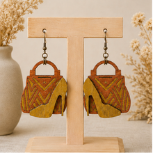 Load image into Gallery viewer, Bag &amp; Heels 3D wooden earrings displayed front-facing on a light wood stand.
