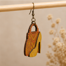 Load image into Gallery viewer, Side detail of Bag &amp; Heels 3D wooden earrings showing the layered wood construction and bronze-tone hook.
