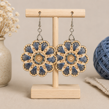 Load image into Gallery viewer, Blue Blossom embroidered wooden earrings displayed front-facing on a light wood stand.
