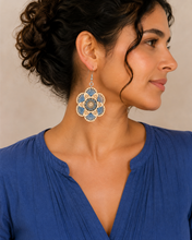 Load image into Gallery viewer, Model wearing Blue Blossom embroidered wooden earrings with a blue blouse and hair pulled back.
