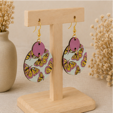Load image into Gallery viewer, Angled view of Boho Chic Butterfly wooden earrings on a light wood stand.
