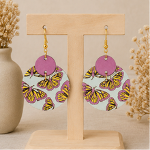 Load image into Gallery viewer, Boho Chic Butterfly wooden earrings displayed front-facing on a light wood stand.

