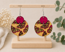 Load image into Gallery viewer, Hand-painted butterfly wooden earrings showing the same finished butterfly design on both front and back.
