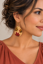 Load image into Gallery viewer, Model wearing lightweight Leaf Whispers engraved wooden earrings with a soft brick top
