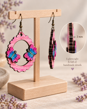 Load image into Gallery viewer, Side view of Mariposa Serena layered wooden earrings showing the 2 mm American linden base and raised butterfly construction
