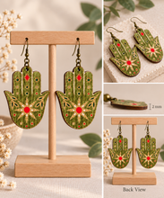 Load image into Gallery viewer, Mystical Hamsa Hand wooden earrings shown in detail with engraved motifs, 2 mm wood thickness, and double-sided design
