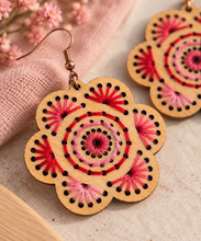 Load image into Gallery viewer, Close-up of Natural Splendor wooden earrings showing hand-embroidered red and pink stitching, natural wood grain, and bronze-tone hook
