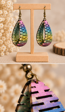 Load image into Gallery viewer, Pearlescent Rainbow wooden earrings with close-up views showing the real curved construction, painted cutouts, and bronze-tone hardware
